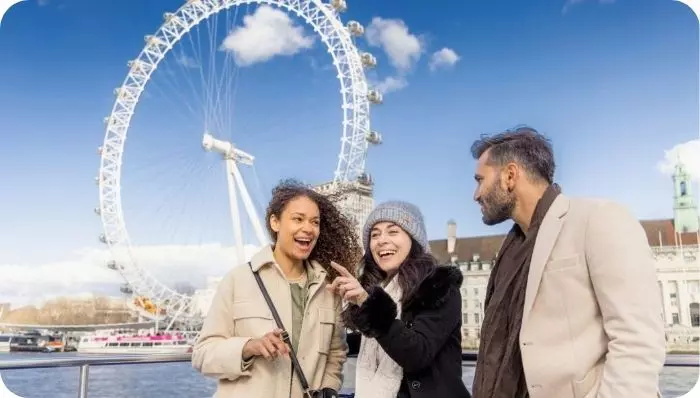 Three people talking on the Thames Cruise